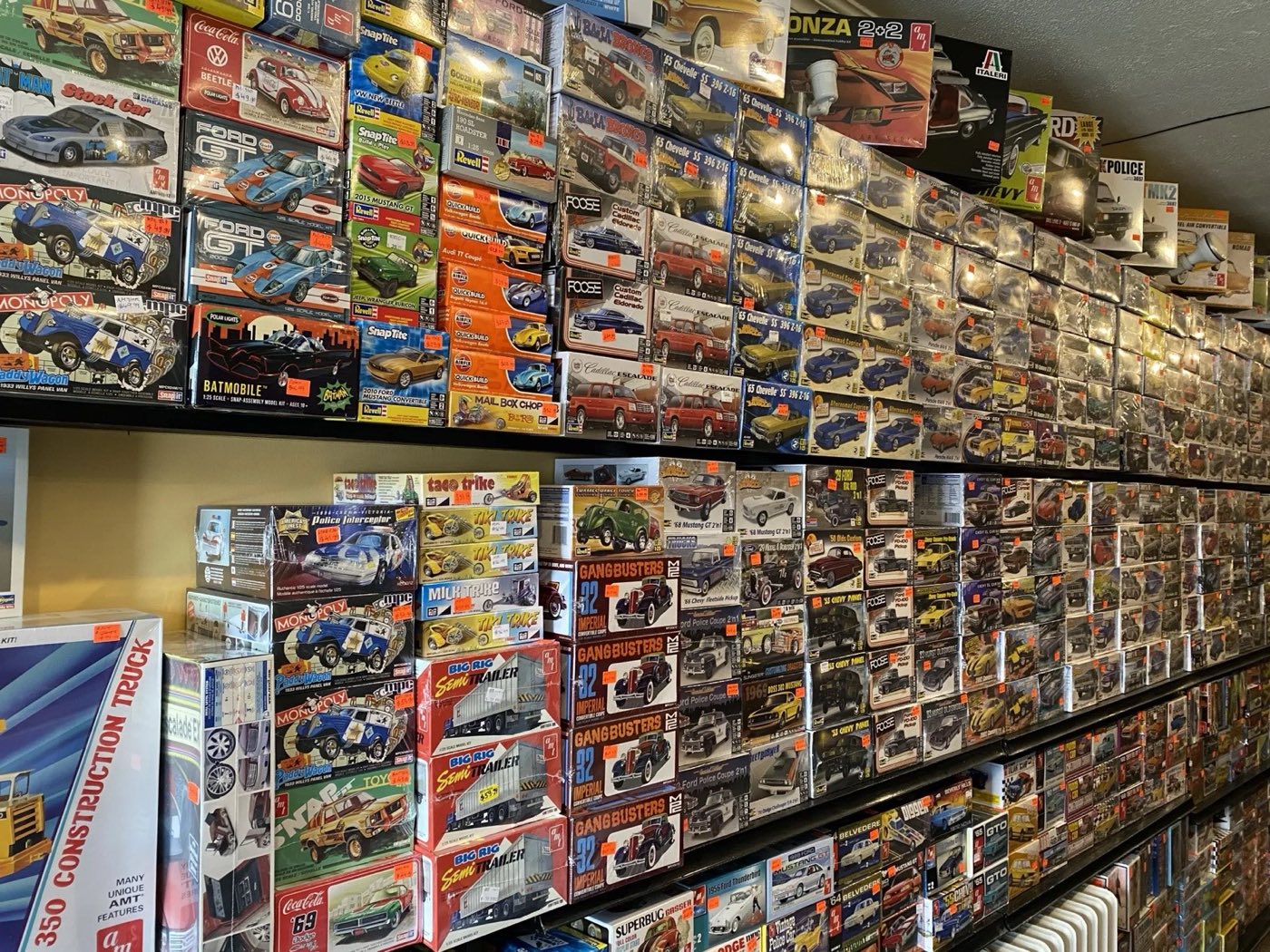 Model car kit shelves inside Hamilton Hobby Specialties, stacked with AMT, Revell, MPC, and Italeri boxes